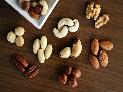 variety-of-brown-nuts-on-brown-wooden-panel-high-angle-photos